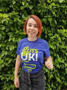 Young woman (Fran) in a Guts UK t-shirt smiling at the camera