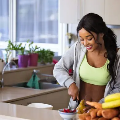 A woman cutting up a pear