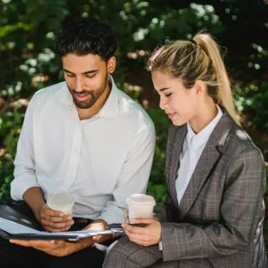 People Discussing Business While Sitting Outside with a Cup of Coffee