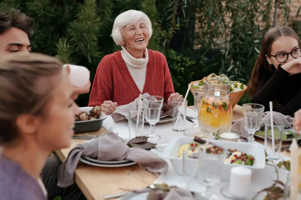 Happy family enjoying dinner in garden 