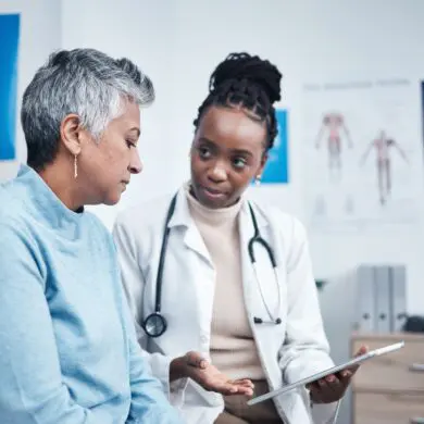 Black woman, doctor and senior patient with computer tablet.