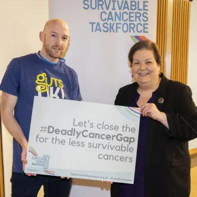 A photograph of Ross Marsden, patient and family advocate, and Jackie Baillie, Member of Scottish Parliament, stand together and smile at the camera.