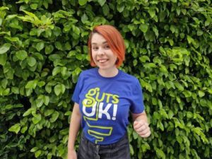 Young woman (Fran) in a Guts UK t-shirt smiling at the camera