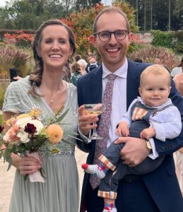 Victoria, Jon and their son, Theodore at a wedding.