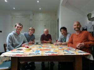 Jim and four family members sit smiling around a table