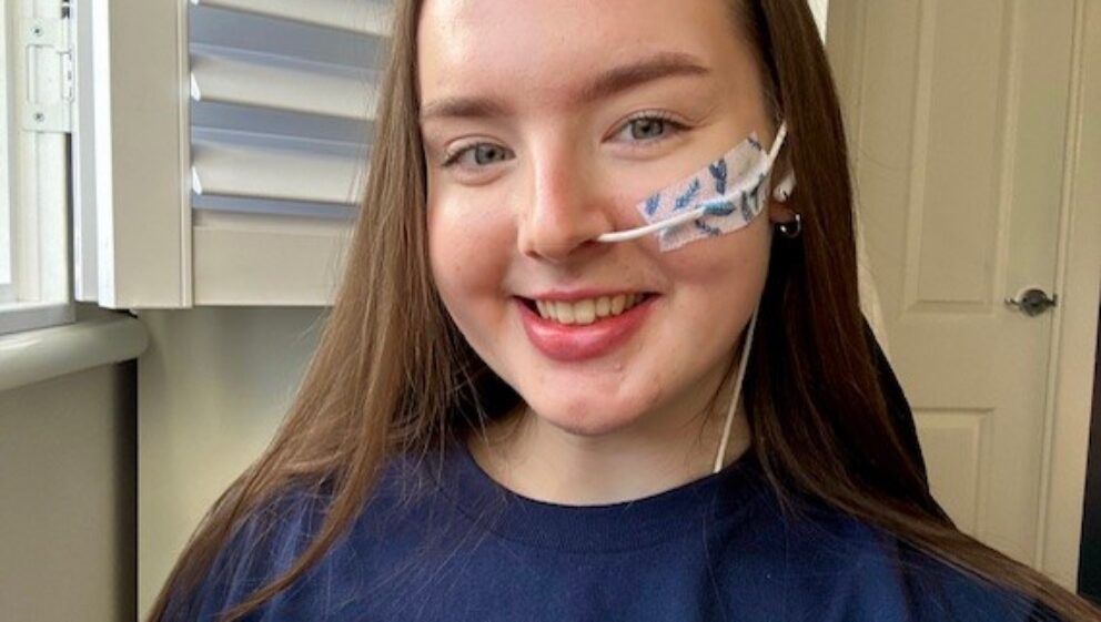 Guts UK supporter Lucy smiling at the camera.