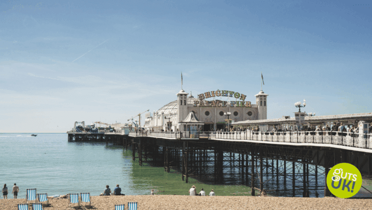 Brighton beach and sea front with Brighton Pier to the right of the shot.