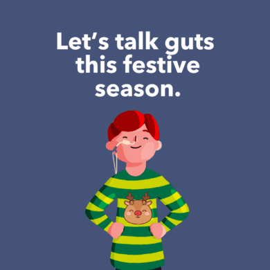 Guts UK's boy brand character is stood up with his hands on his hips, smiling. He has a feeding tube going into one nostril and three festive baubles are to the right of him. Text reads 'Let's talk guts this festive season.'